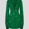 Front of green mini jacquard dress with balloon sleeves and deep v neck.